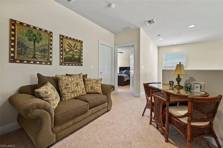 Sitting area upstairs featuring carpet