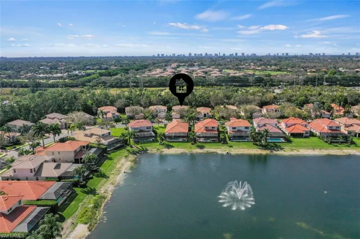Aerial perspective of suburban area featuring a large body of water
