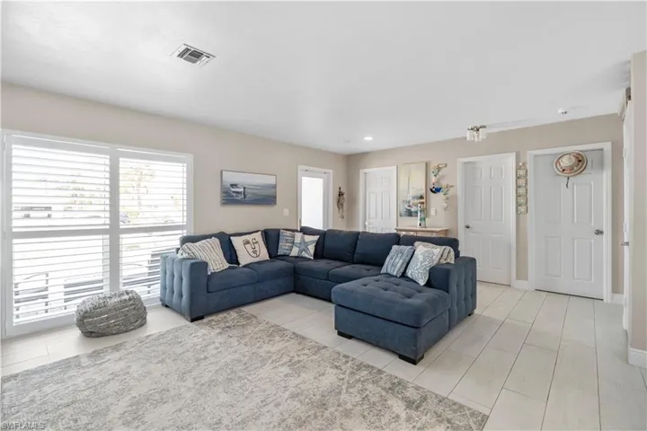 Living room with healthy amount of natural light and recessed lighting