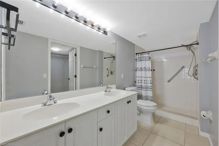 Full bath featuring toilet, a sink, tile patterned flooring, and visible vents