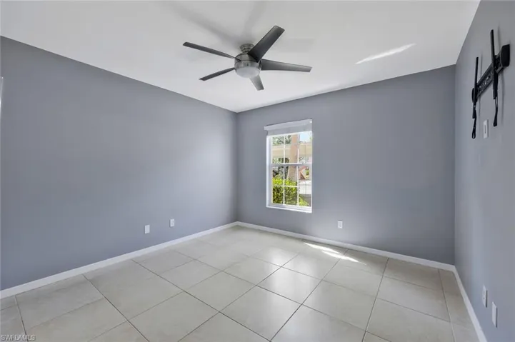 Spare room featuring tile patterned floors, baseboards, and a ceiling fan