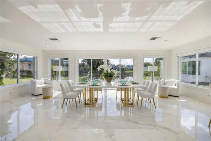 Sunroom with healthy amount of natural light and a water view