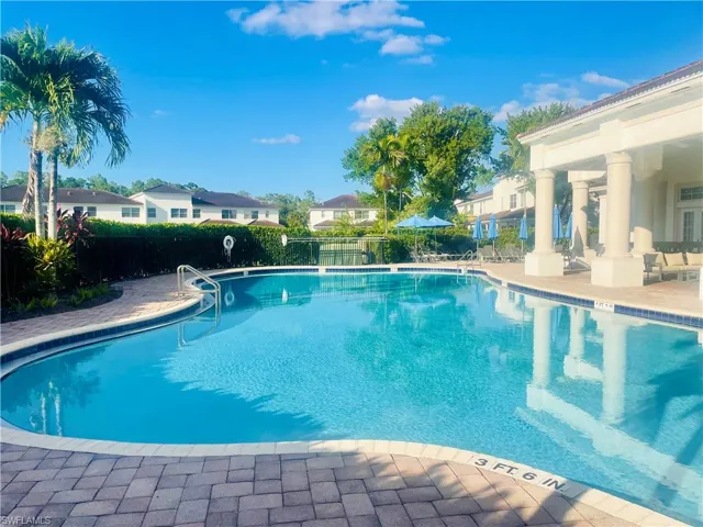 Community pool with a patio and a residential view