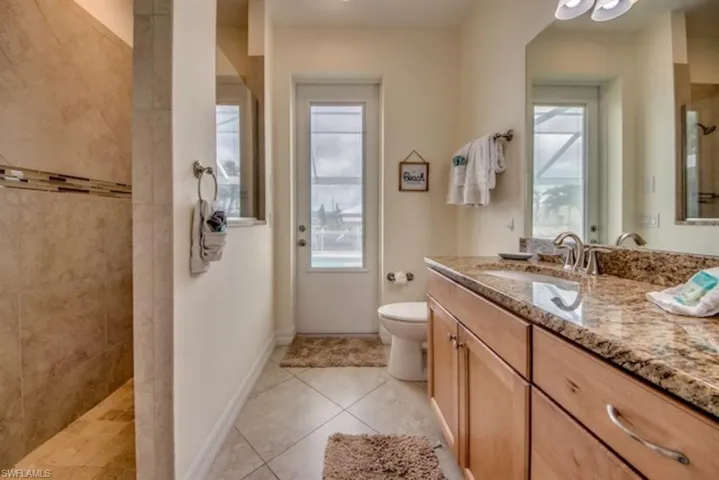 Bathroom with tile flooring, toilet, and vanity