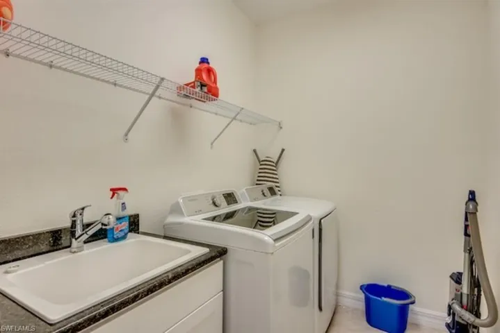 Washroom with sink and independent washer and dryer