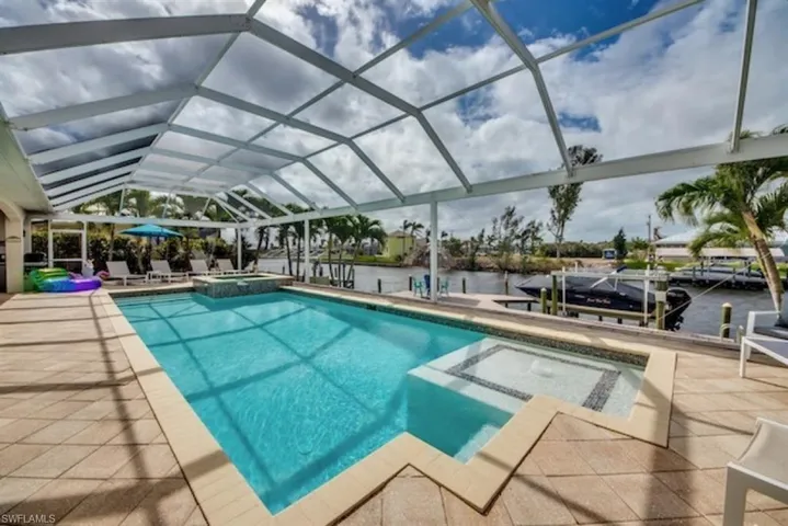View of pool featuring glass enclosure
