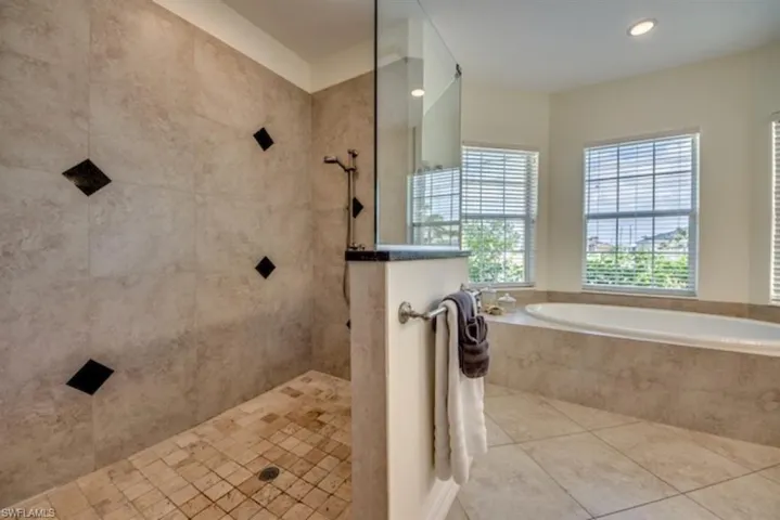 Bathroom featuring tile flooring and independent shower and bath
