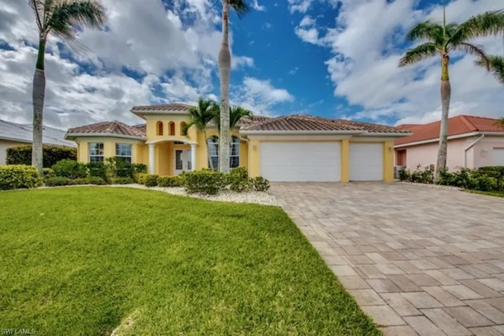 Mediterranean / spanish house with a garage and a front lawn