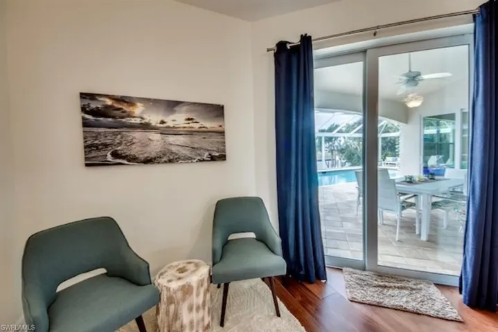 Living area with wood-type flooring and ceiling fan