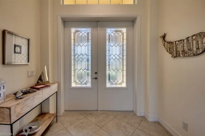 Tiled entryway featuring french doors and plenty of natural light