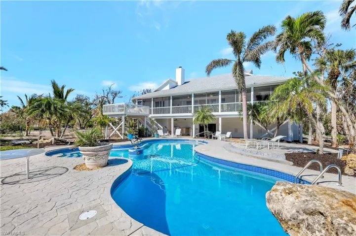 View of swimming pool featuring a patio area and a sunroom