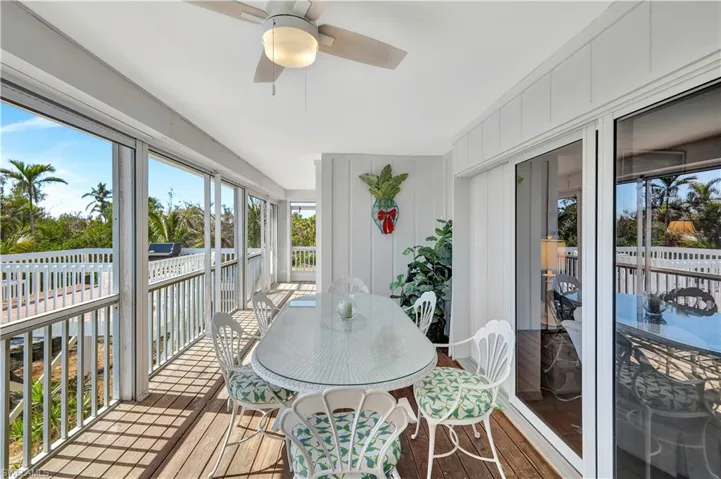 Sunroom / solarium featuring ceiling fan