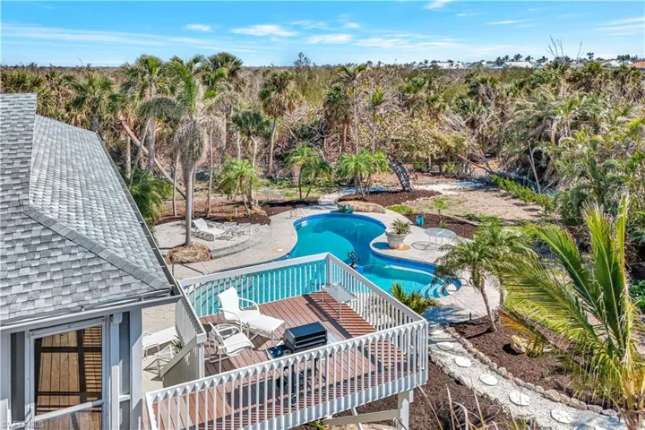 View of swimming pool with a wooden deck
