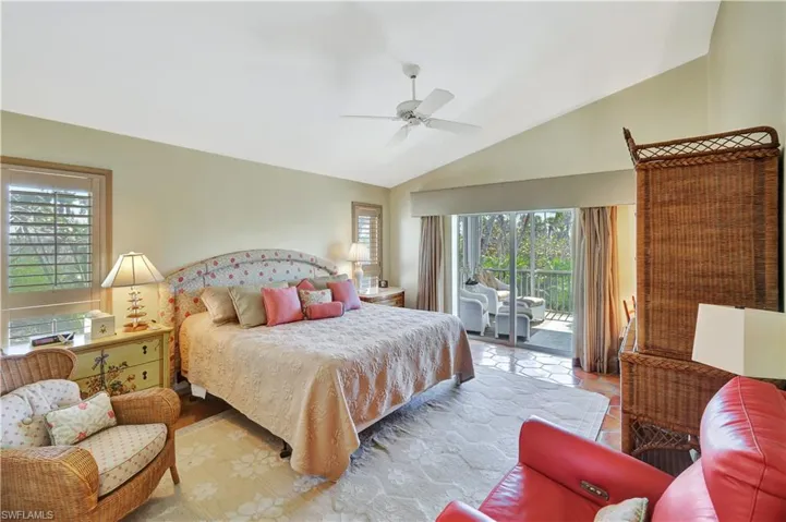 Bedroom featuring vaulted ceiling, access to outside, and ceiling fan