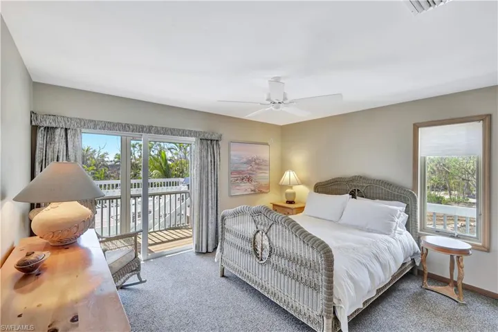 Bedroom featuring access to outside, ceiling fan, and carpet flooring