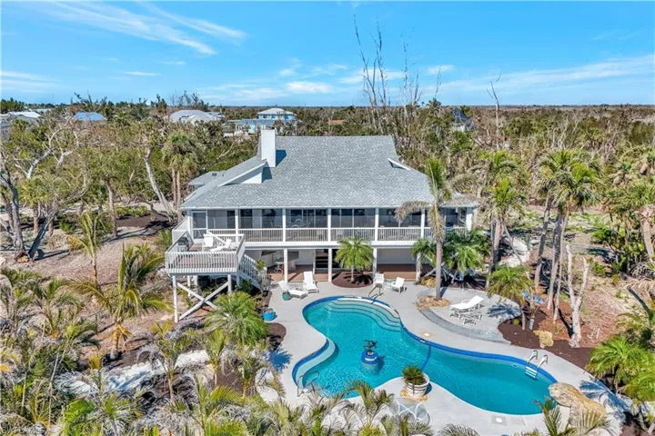 View of swimming pool with a patio area and a sunroom