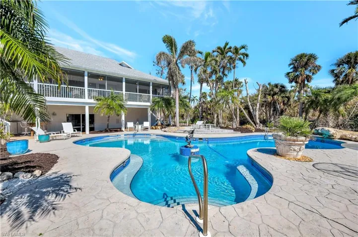 View of swimming pool featuring a patio area and a sunroom