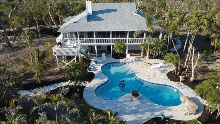 View of swimming pool featuring a sunroom and a patio