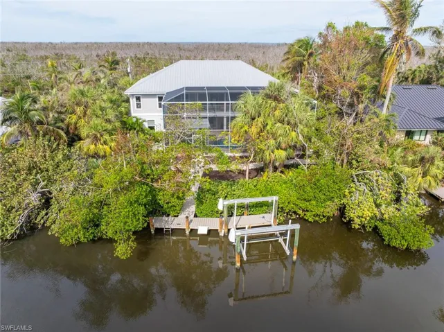 View of dock with a water view and a lanai