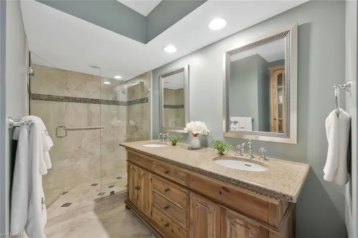 Nice wood cabinetry in the guest bath with walkin showing.