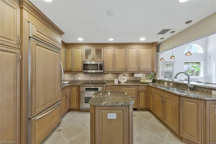 Custom wood cabinets with both the the appliances having matching panels.