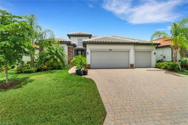 Mediterranean / spanish-style house featuring a garage and a front lawn