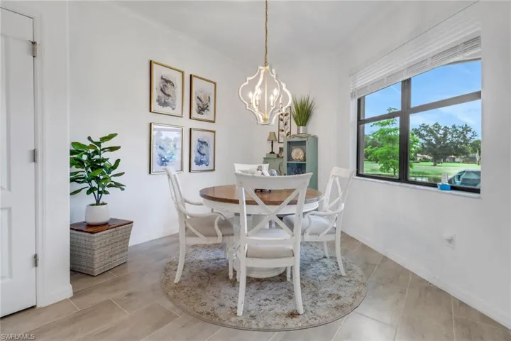 Dining space with ornamental molding and a notable chandelier