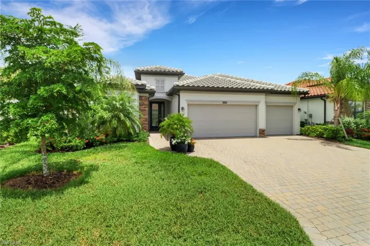 Mediterranean / spanish-style house featuring a 3 car garage and paver drive