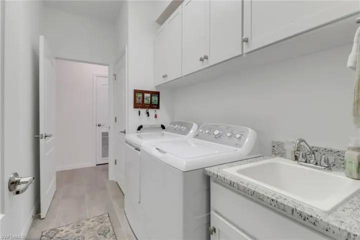 Overhead cabinets in laundry sink.