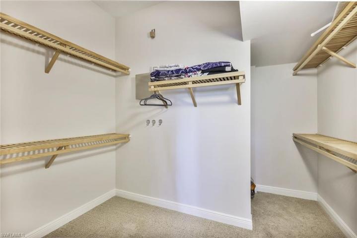 MBR Super Sized Walk in Closet w/wood rack/shelving