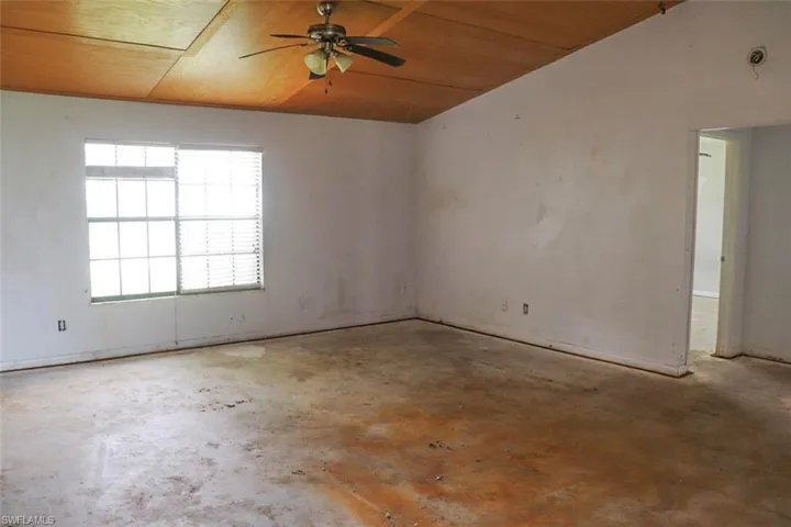 Empty room with wood ceiling and ceiling fan