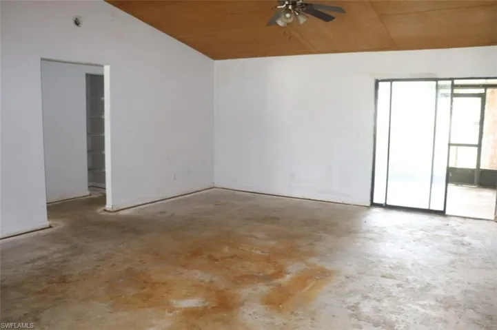 Unfurnished room featuring wood ceiling and ceiling fan