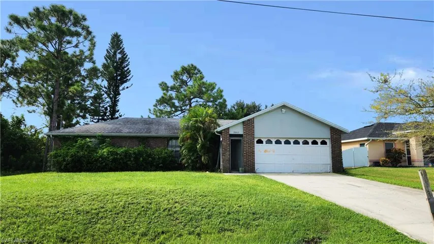 Single story home with a front lawn and a garage