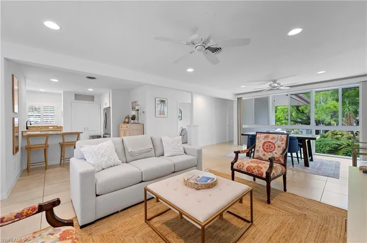 Living area featuring light tile patterned flooring, recessed lighting, and ceiling fan