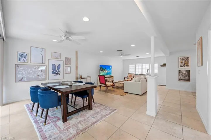 Dining area with a ceiling fan, recessed lighting, and light tile patterned floors