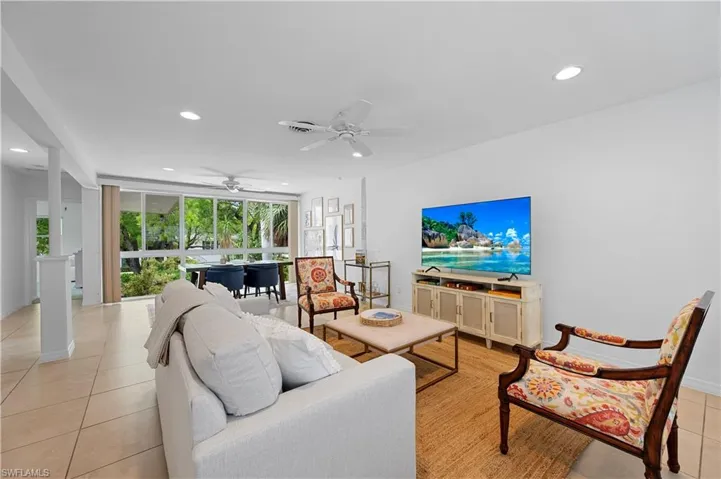 Living area featuring light tile patterned floors, a ceiling fan, recessed lighting, and floor to ceiling windows