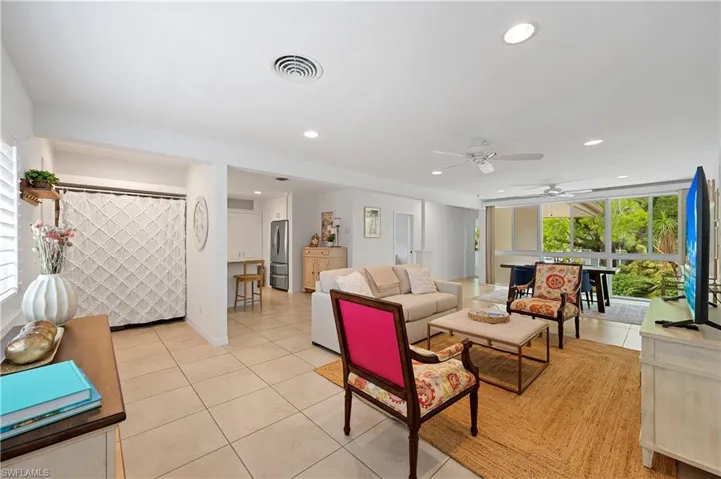 Living room with plenty of natural light, light tile patterned floors, a ceiling fan, and recessed lighting