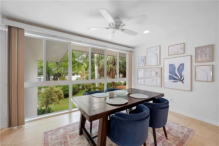Dining space featuring expansive windows, a ceiling fan, light tile patterned floors, and recessed lighting