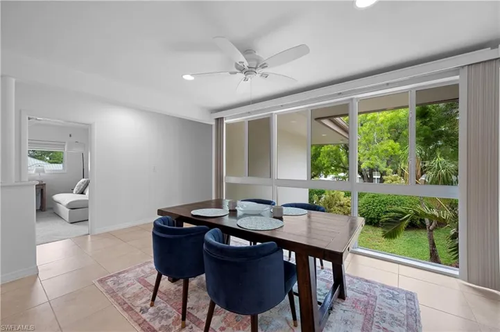 Dining room with light tile patterned flooring, recessed lighting, and ceiling fan