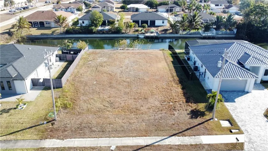 Aerial view of residential area featuring a large body of water