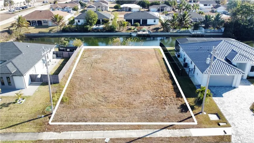 Aerial perspective of suburban area with a nearby body of water