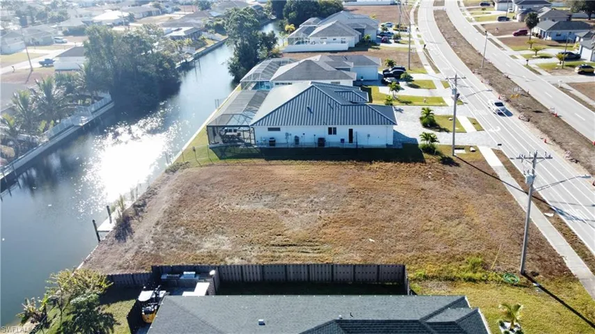 Aerial view of residential area featuring a large body of water