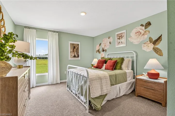 Carpeted bedroom with baseboards
