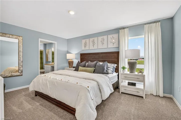 Bedroom featuring carpet and ensuite bathroom