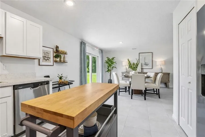 Dining space featuring a textured ceiling, recessed lighting, and light tile patterned flooring