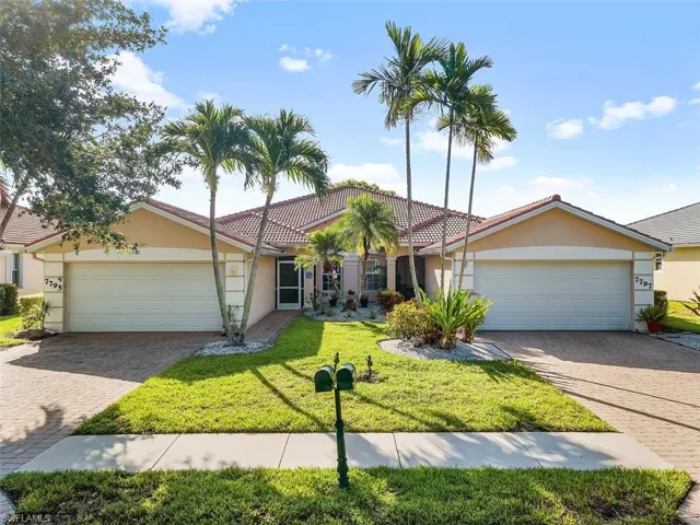 View of front of house with a garage and a front yard