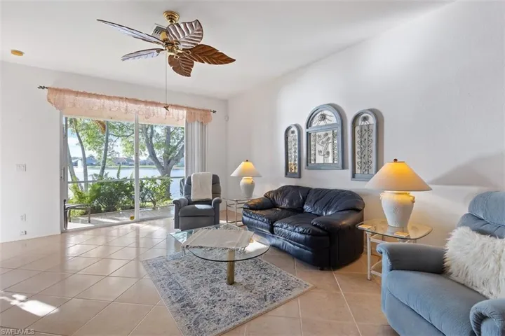 Living room with light tile flooring and ceiling fan