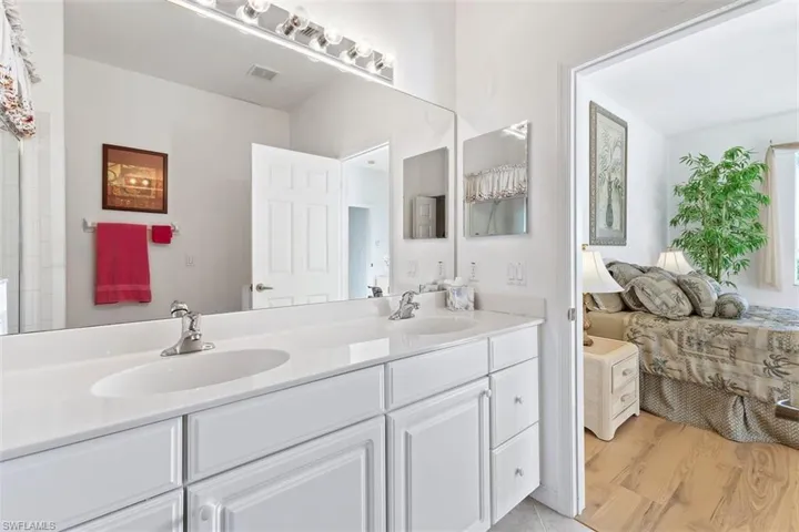 Master Bathroom featuring wood-type flooring and double sink vanity