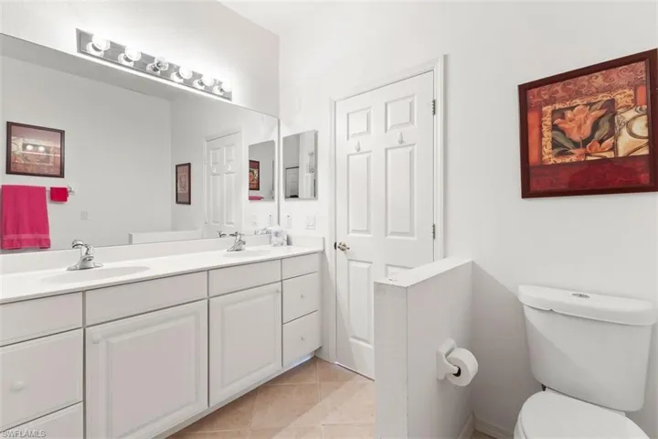 Master Bathroom featuring dual vanity, toilet, and tile floors