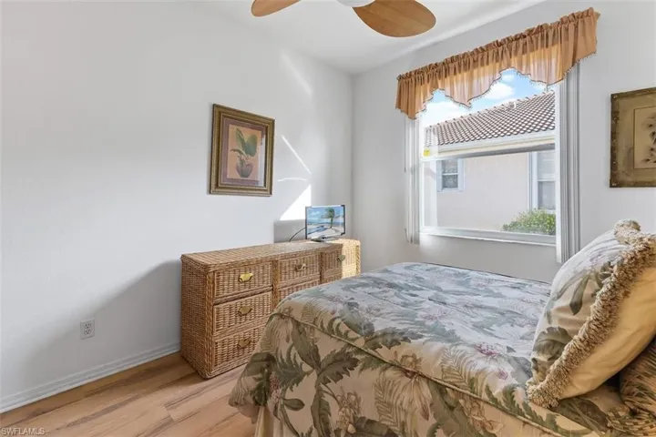 Bedroom with ceiling fan and light hardwood / wood-style flooring